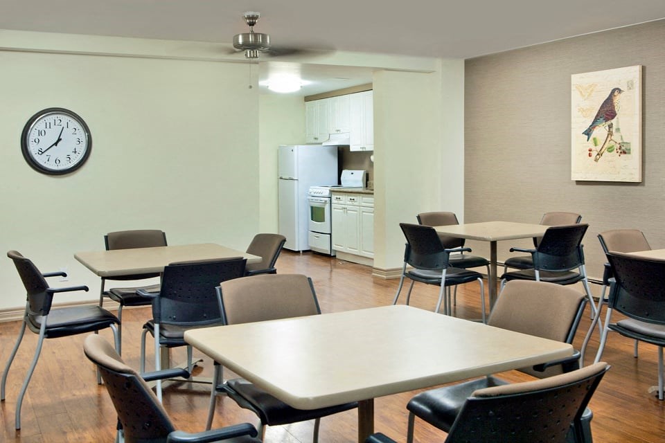 Laura Secord Apartments social room leading into social room kitchen in Niagara Falls, ON