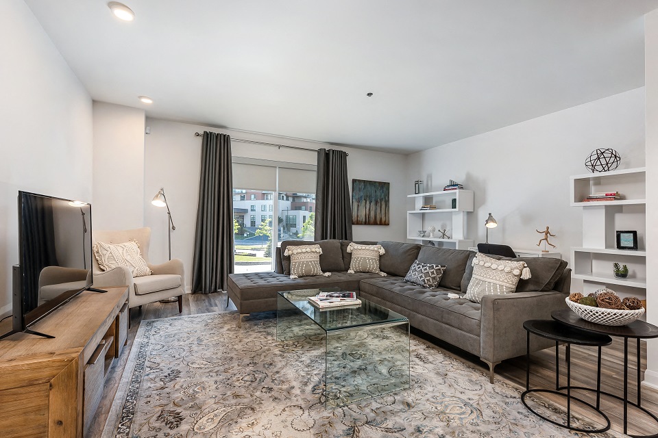 Large spacious living room with walk out patio at Le Saint-Laurent Apartments in Brossard