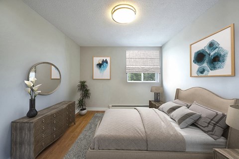 A bedroom with a large bed and a mirror on the wall.