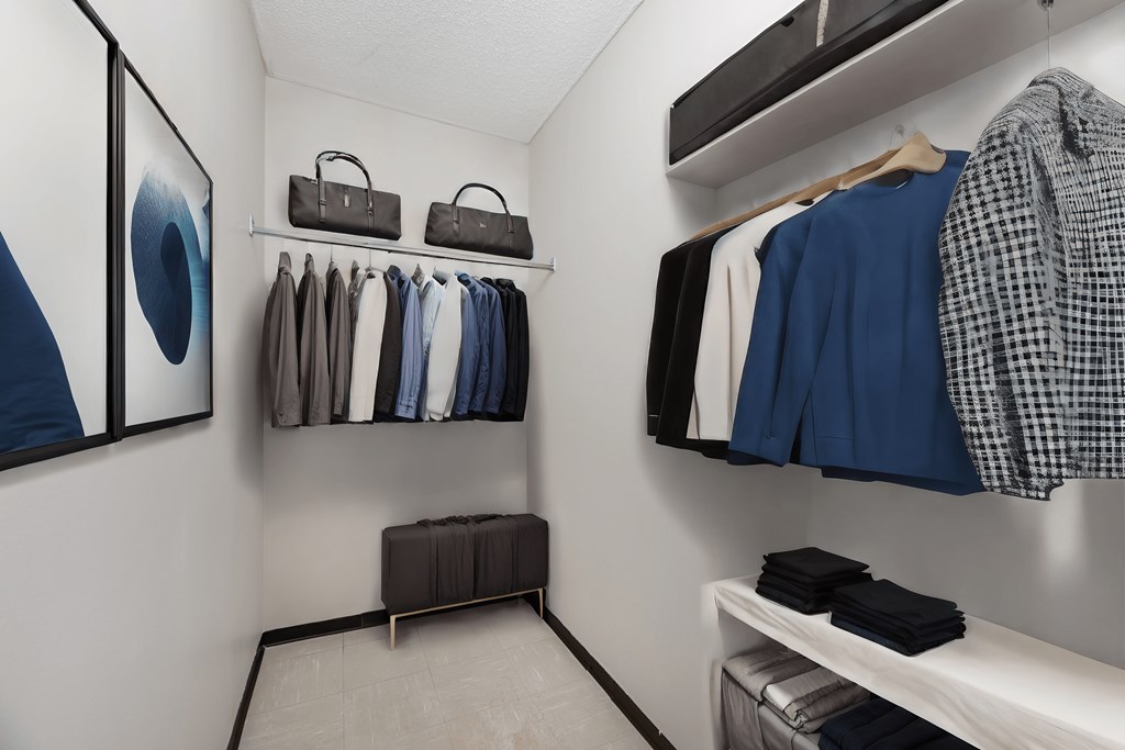 a closet filled with clothes and accessories and a mirror on the wall at Les Jardins Hauterives