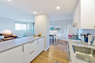 Les Jardins Hauterive in Sherbrooke, QC kitchen with breakfast bar and modern cabinetry