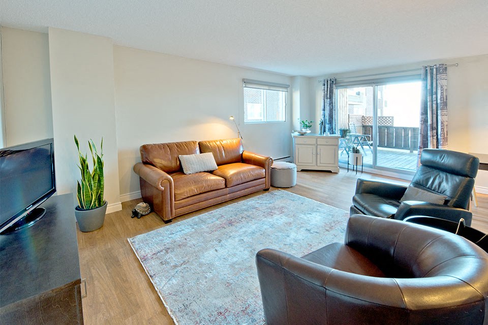 Les Jardins Hauterive in Sherbrooke, QC spacious living room with access to private balcony