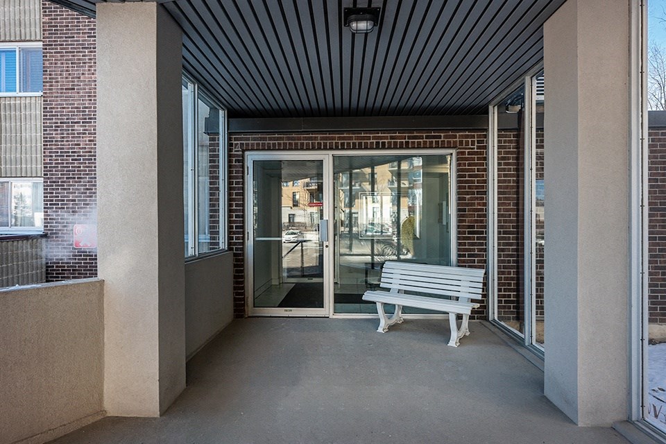 a white bench sitting outside of a building