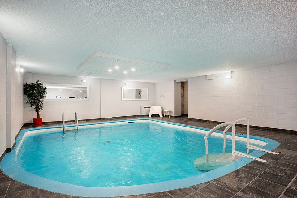 a swimming pool with a ladder in the middle of it