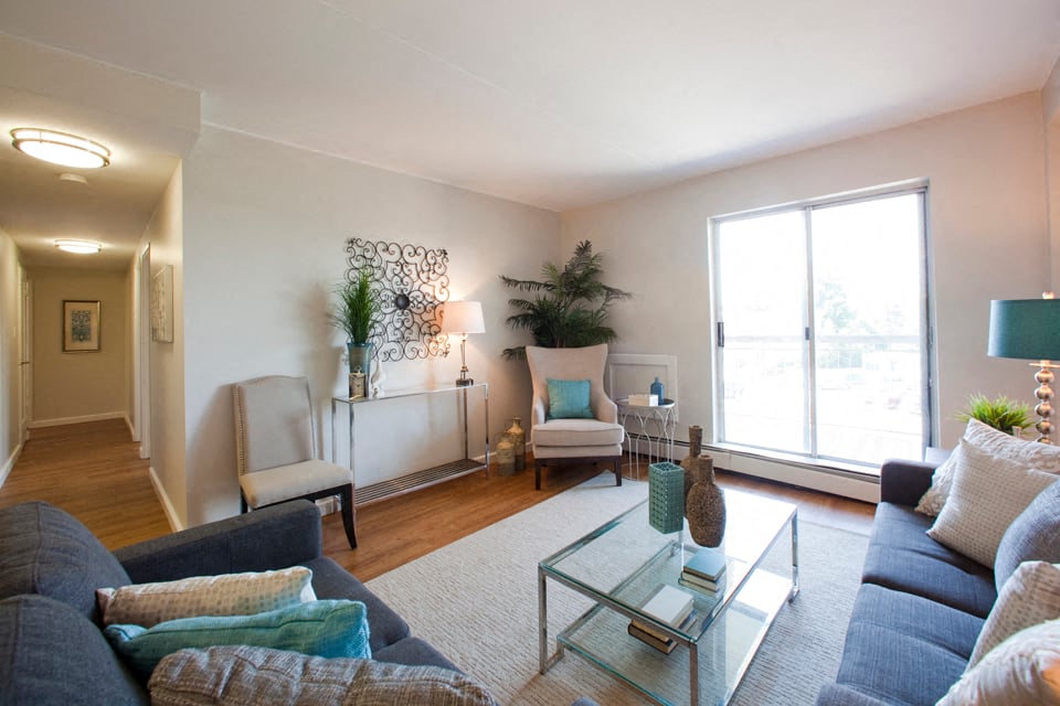 a living room with a couch and a glass coffee table