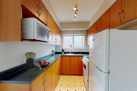 a kitchen with a microwave and a refrigerator