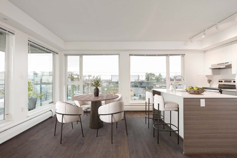 A modern kitchen with a dining table and chairs at 388 Kaslo East Village.