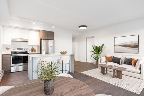 A modern living room with a wooden floor and a white sofa at 388 Kaslo East Village.