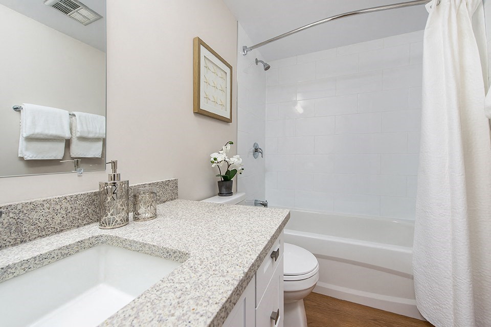 Premium bathroom with stone countertops in an open-concept layout at Lorneville Apartments in Cornwall, ON