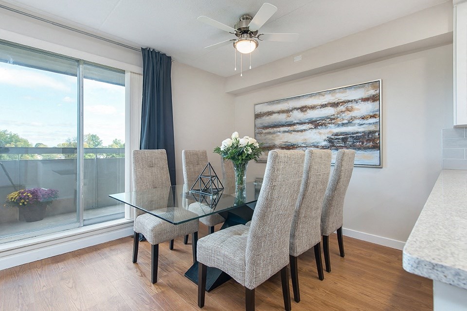Dining room with a large 6-seater dining set in an open-concept dining room at Lorneville Apartments in Cornwall, ON