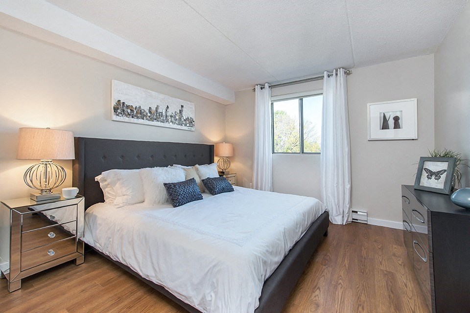 Primary bedroom, as seen from doorway and looking towards a window, in an open-concept 2 bedroom layout at Lorneville Apartments in Cornwall, ON