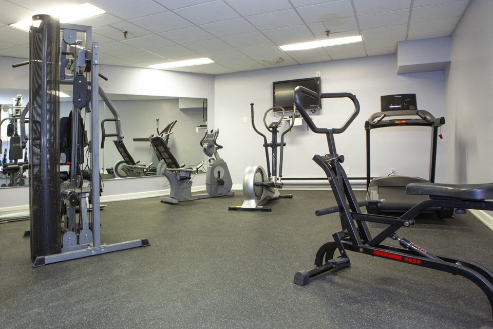 Fitness facility with cardio equipment and weight machine at Lorneville Apartments in Cornwall, ON
