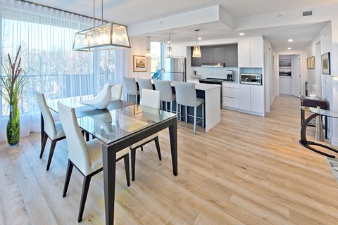 a dining room and kitchen with a table and chairs