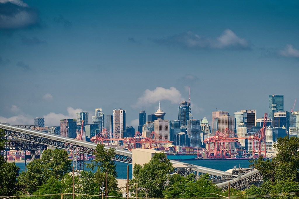 a city skyline with a bridge in the foreground