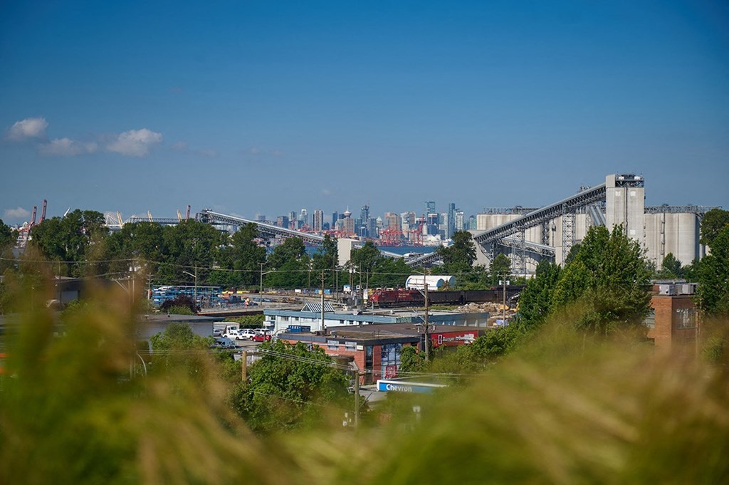 a cityscape with a bridge in the foreground and a city in the background