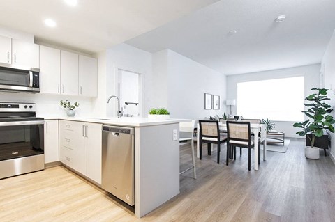 an open kitchen and dining room with a table and chairs