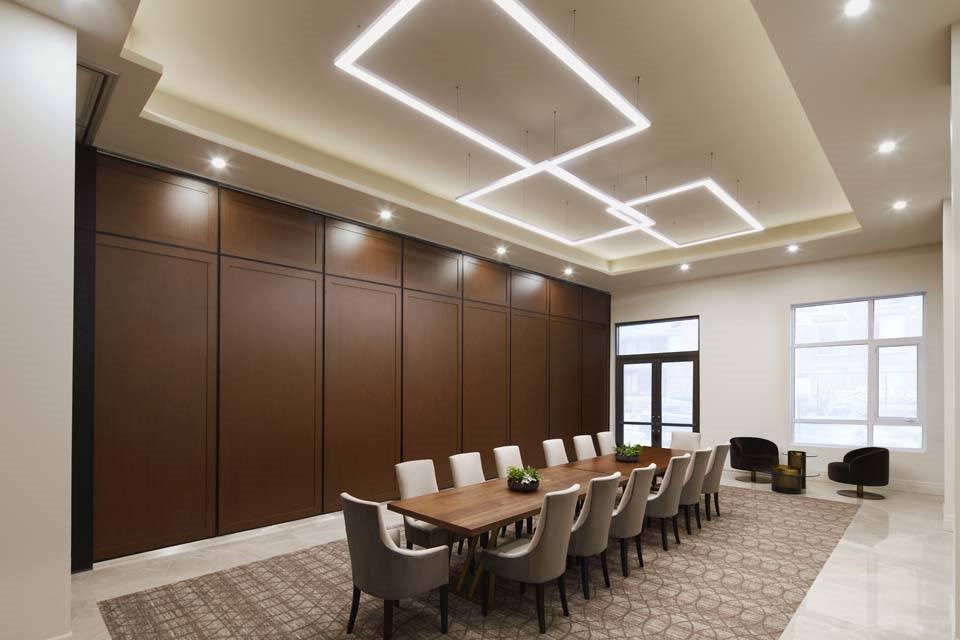 A conference room with a long table and chairs.