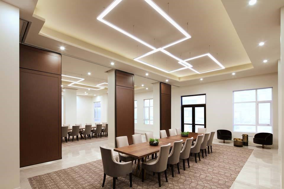 A conference room with a long table and chairs.