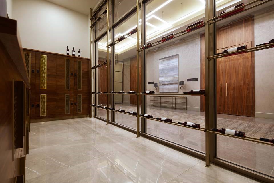 A hallway with a marble floor and a row of lockers on the right side.