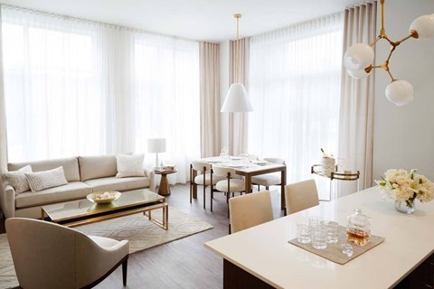 A modern living room with a dining table and chairs.