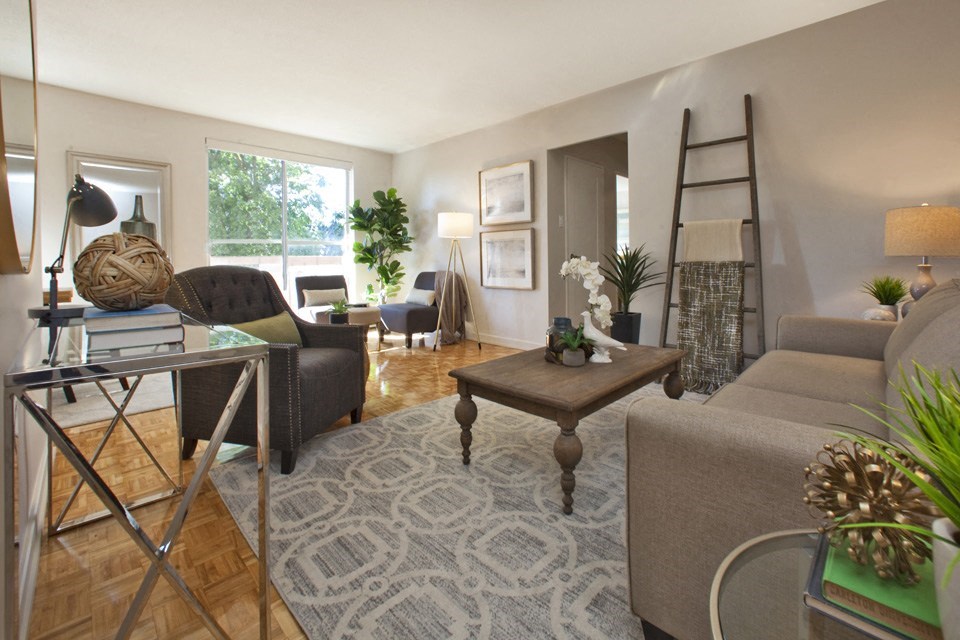 Millside Apartments in Milton, ON bright living room with access to private balcony