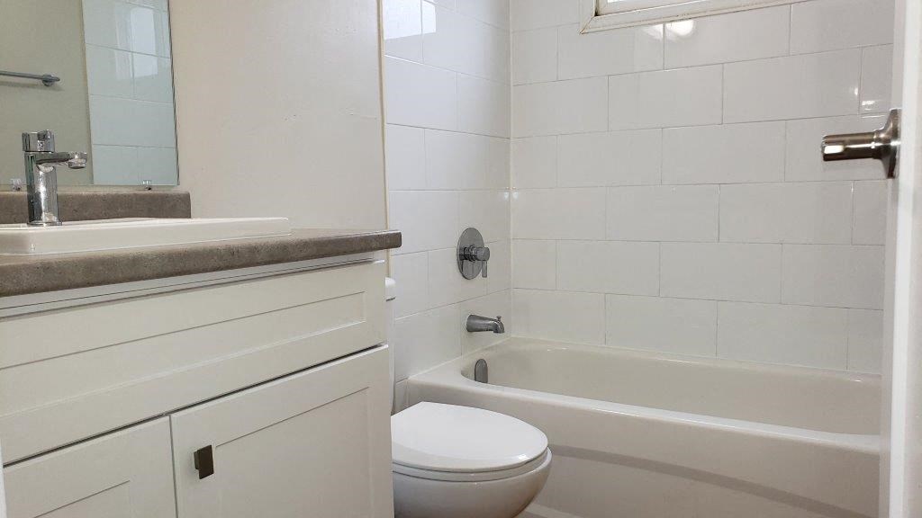Refinished bathroom in an open concept suite at Moira Apartments in Belleville, ON.