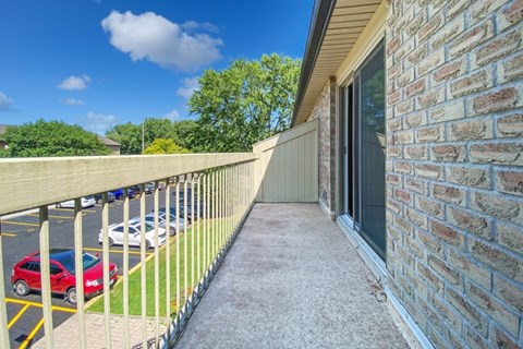 A private balcony overlooking the parking lot at Moira Apartments in Belleville, ON