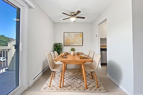 A dining room with a table at Moira Apartments in Belleville, ON