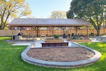 Large outdoor gazebo with BBQ and ample seating at Northgate Tower Apartments in Woodstock, ON