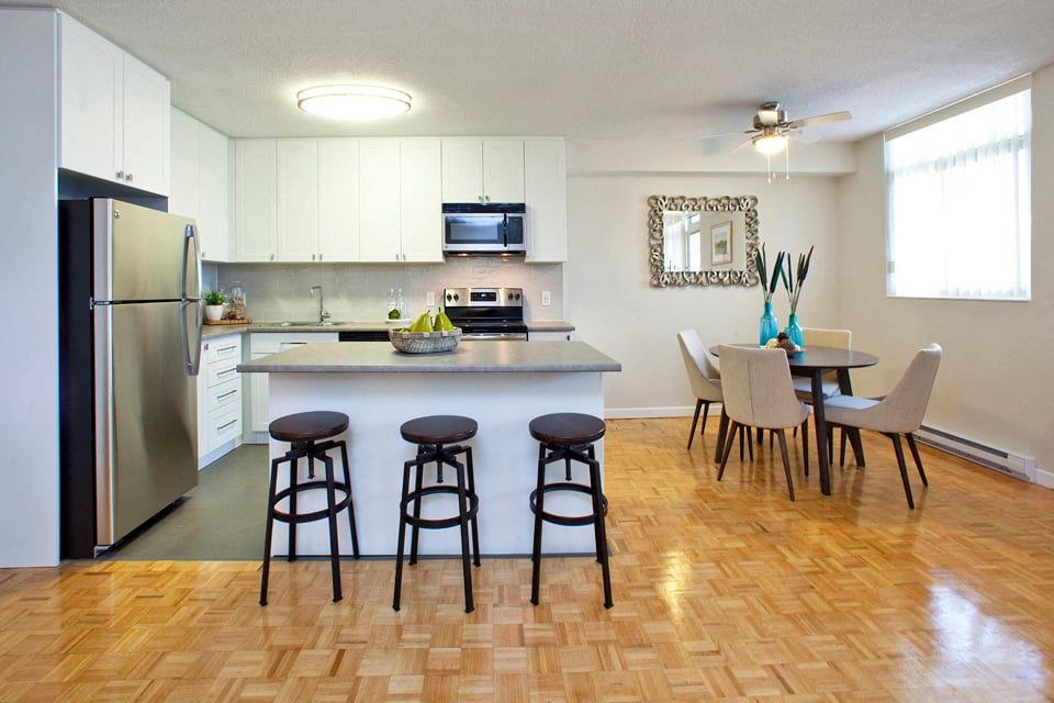 Northumberland modern kitchen with white cabinetry and breakfast bar in Port Hope, ON