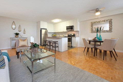 A modern kitchen with a glass table and chairs.
