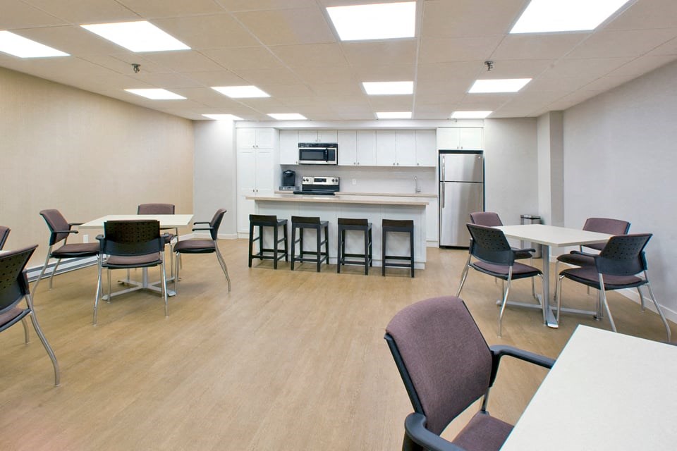 Northumberland Place social room with kitchen and tables and chairs in Port Hope, ON