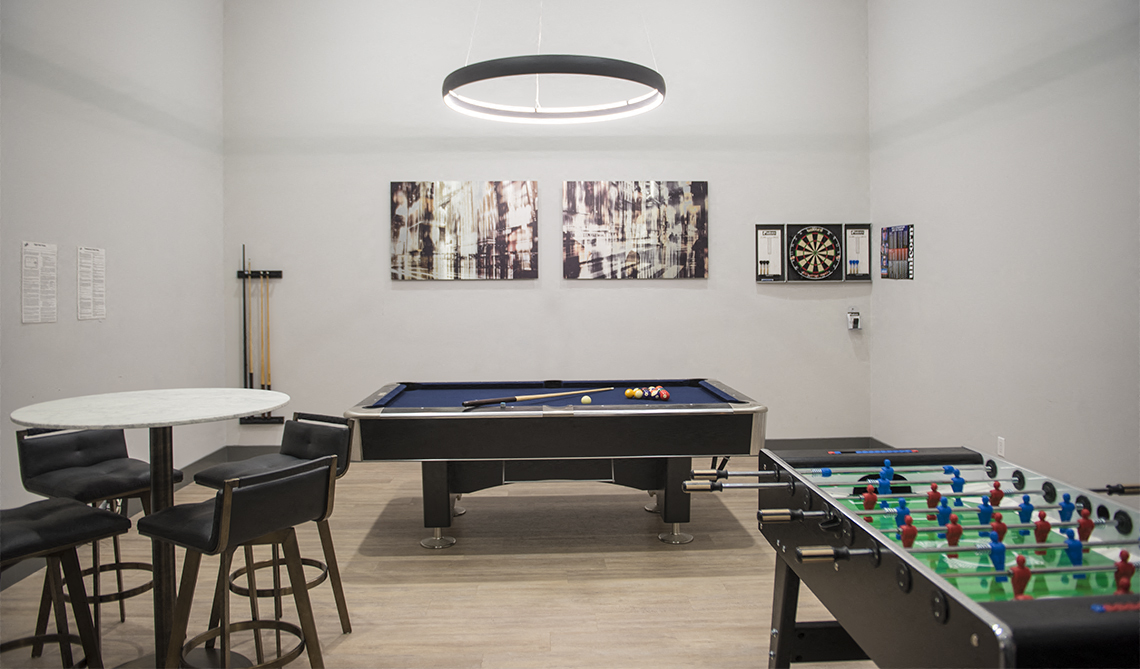 Game room with pool table, Foosball table, and seating