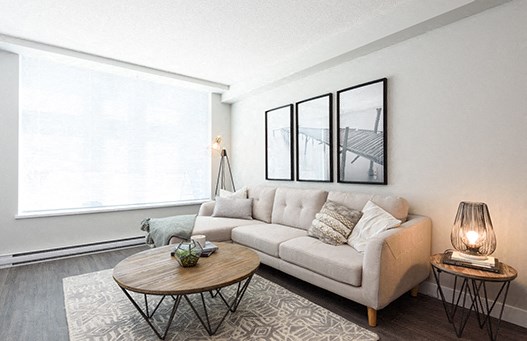 Open living room with large windows currently covered by closed blinds