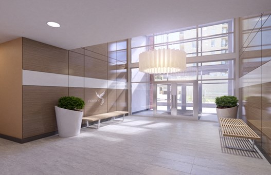 Refined lobby with tall glass windows letting natural light shine through into the building.