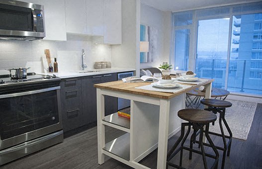 Full kitchen with center island and a view of the balcony