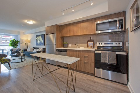 a kitchen with stainless steel appliances and a table