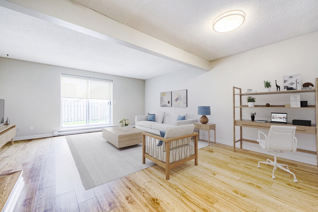 living room with a couch and a table and a window at Oakdale Heights in St. Catharines in ON