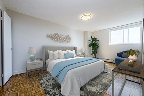 Primary bedroom, with a queen size bed and side tables and sliding window with blackout roller blinds at Park Place Apartments in Bradford, ON