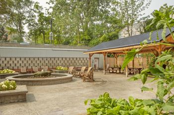 a patio with chairs and a fire pit