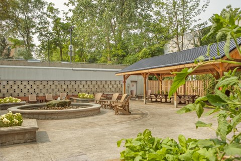 a patio with chairs and a fire pit