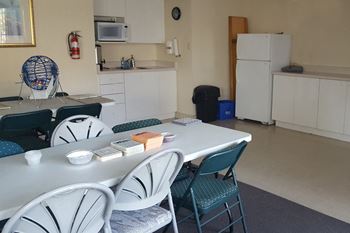 a social room with a table and chairs at Prince William Apartments in Belleville ON