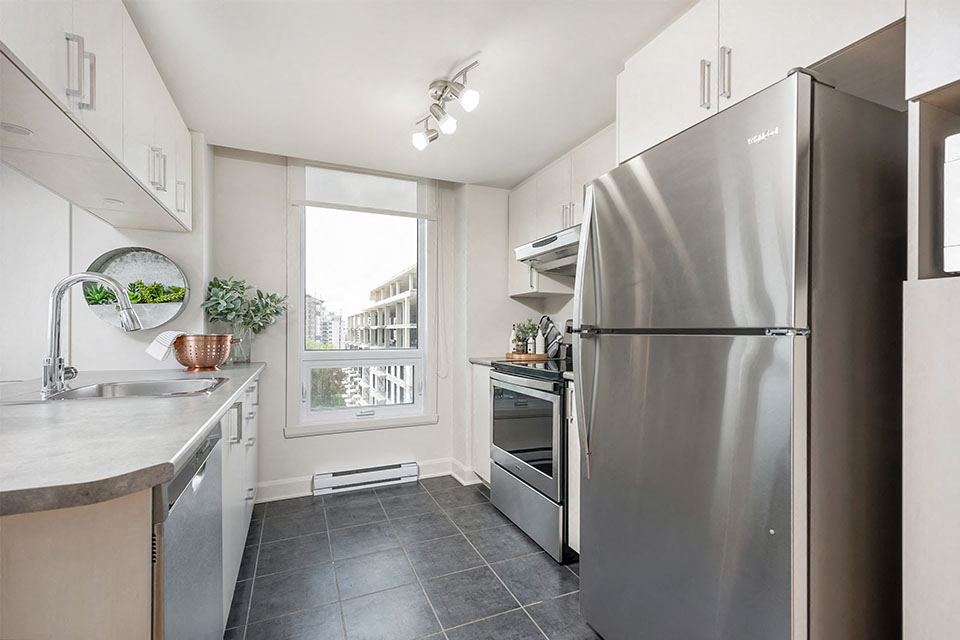 Kitchen with stainless steel appliances at Axial Towers