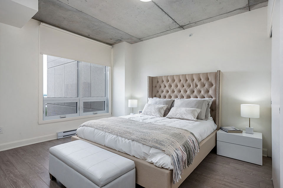 Spacious bedroom with luxury vinyl flooring at Axial Towers