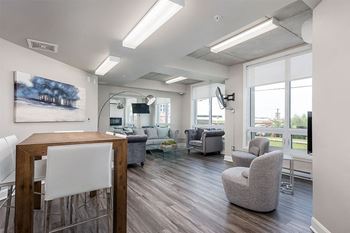Social room with lounge seating and flat screen TV at Axial Towers in Chomedey Laval, Quebec