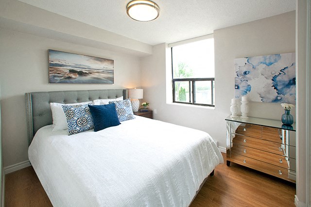Elegant bedroom with hard surface flooring in Whitby, ON