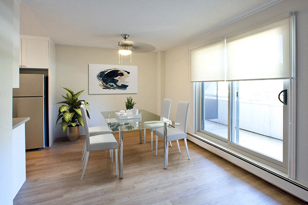 Regency Towers spacious dining room with hard surface flooring and access to balcony in Owen Sound, ON