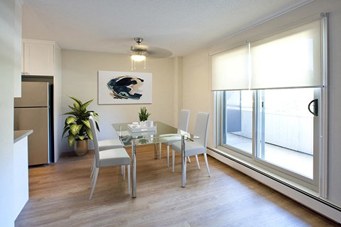 Regency Towers spacious dining room with hard surface flooring and access to balcony in Owen Sound, ON