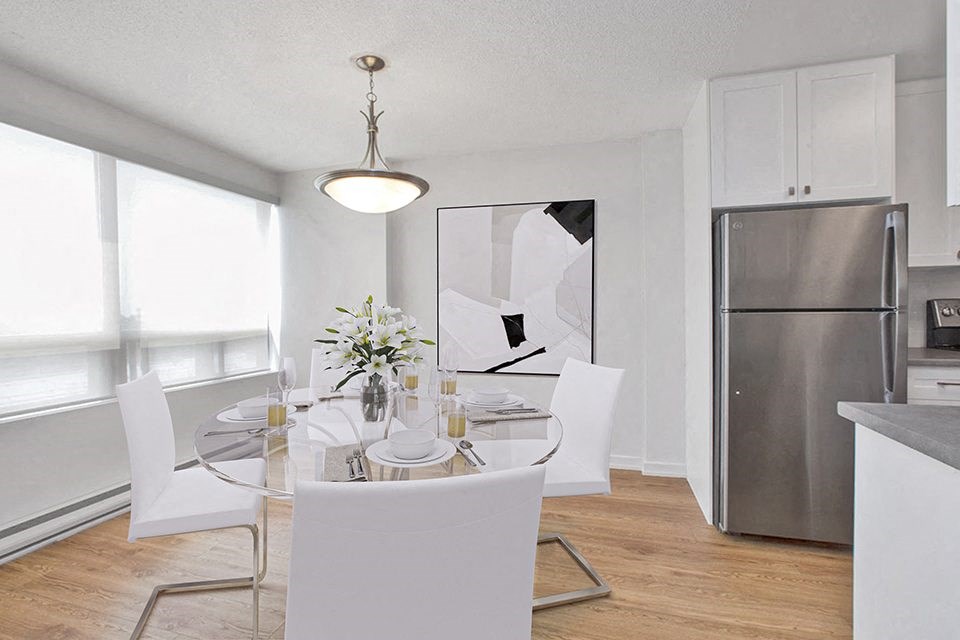 Dining area with large window and table and chairs