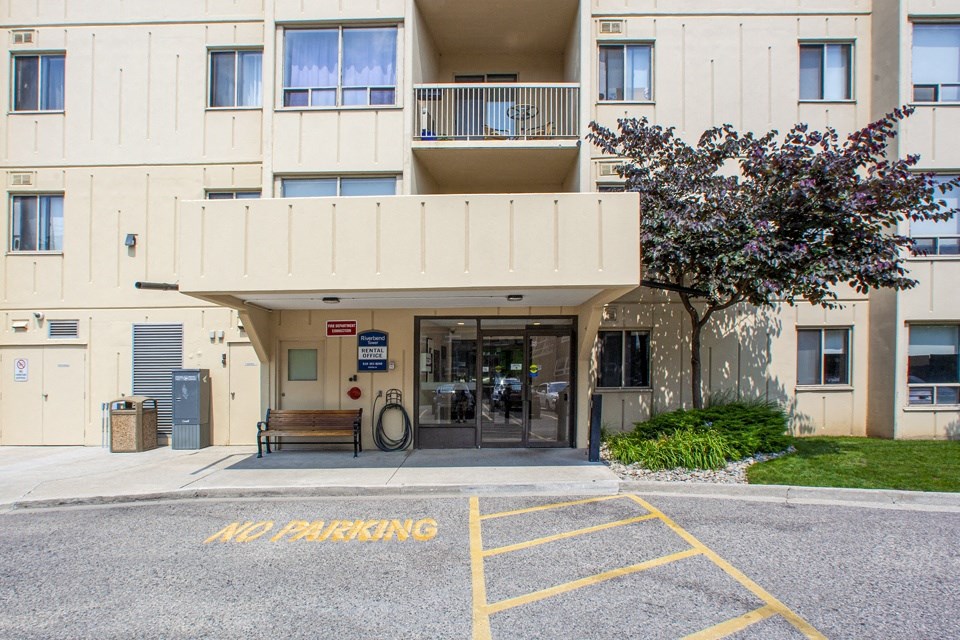 Main building entrance as seen from parking lot at Riverbend Tower Apartments in Chatham, ON